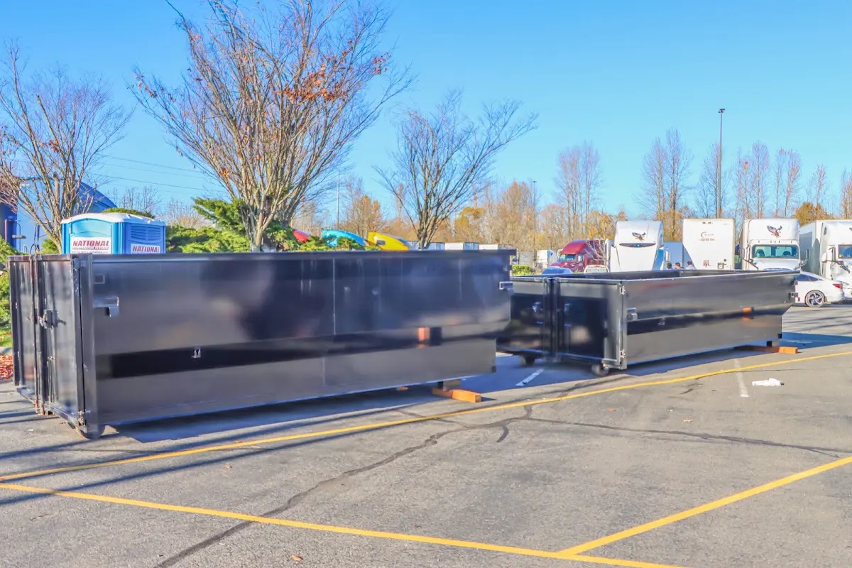 Professional dumpster rental service with roll-off container on residential driveway in Totowa